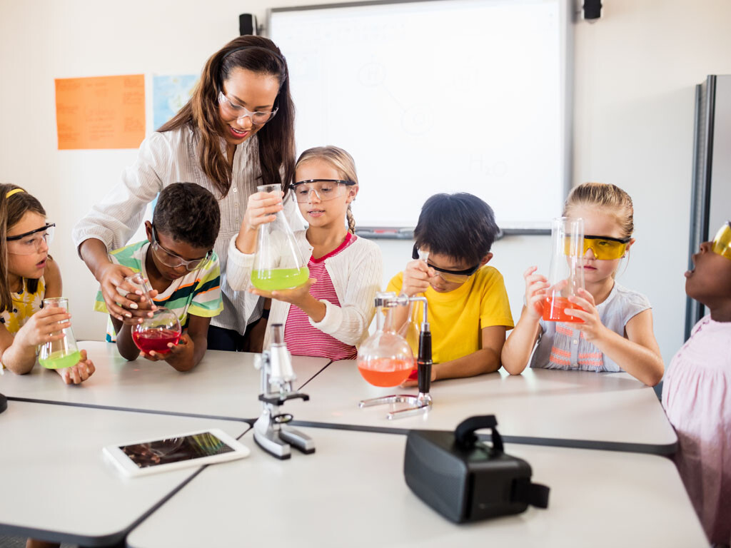 stock image of science teacher working with students