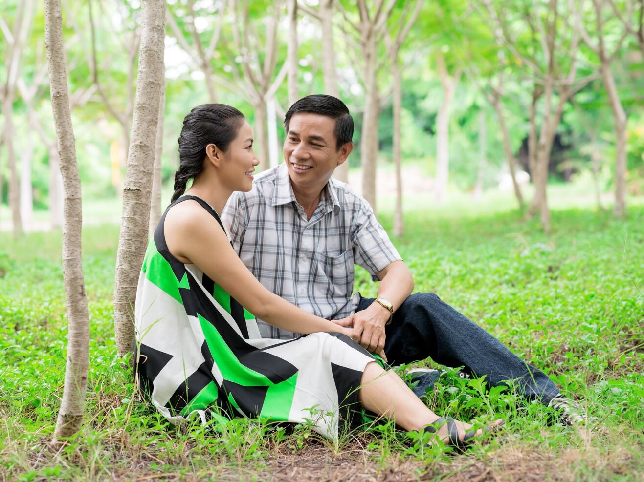 Asian couple in woods relaxing