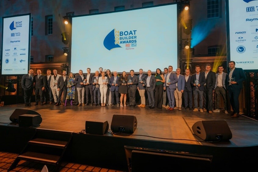 group of people on stage receiving the Boat builder award 2022